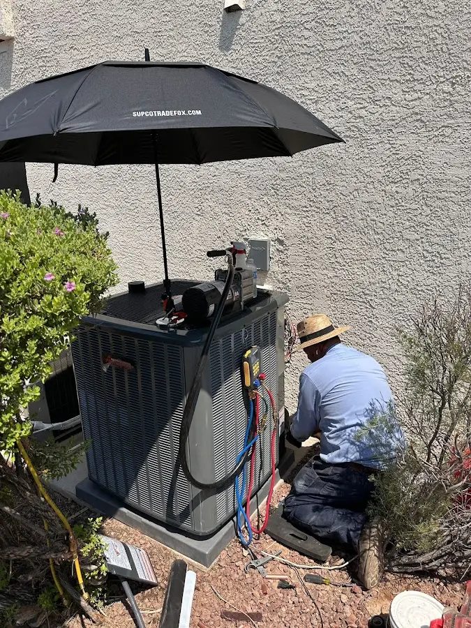 HVAC technician performing outdoor AC maintenance in Wallingford